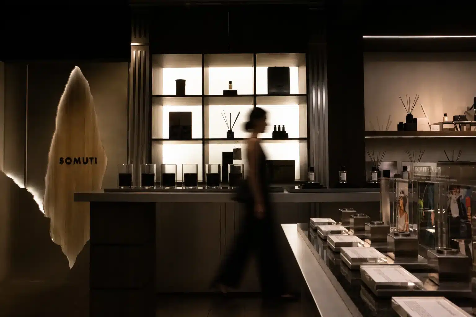 Inside the Somuti perfume boutique on Song Wat Road, Bangkok, with candles and reed diffusers on softly lit shelves