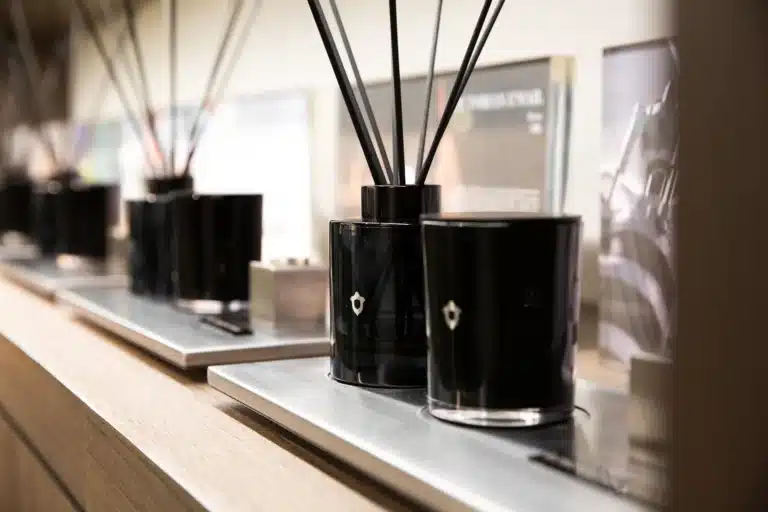 Somuti reed diffusers and candles on a shelf