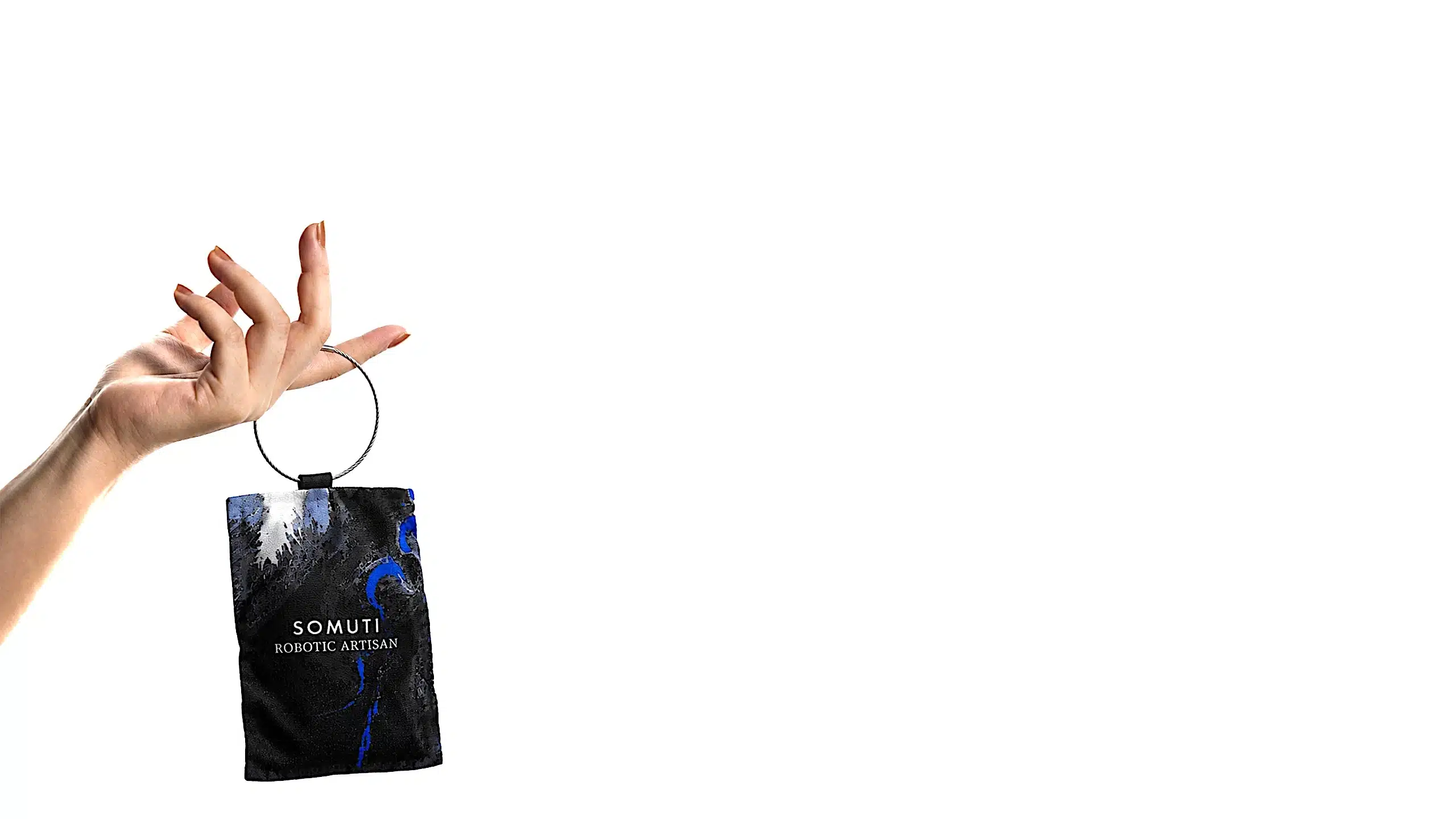 Hand holding a Somuti Robotic Artisan scented sachet by its ring